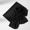 Black jersey hijab neatly folded on white background