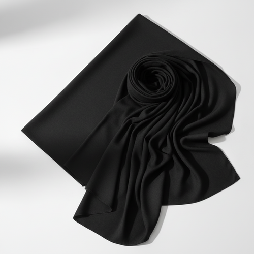 Black jersey hijab neatly folded on white background